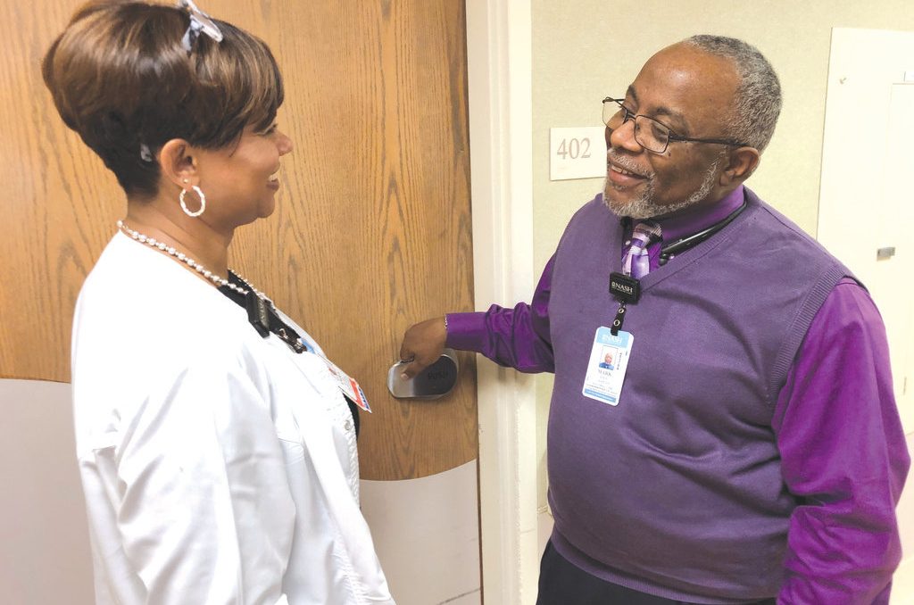Chaplain Mark Dickens talks with a case manager, registered nurse Enola Hicks, before entering a patient’s room at Nash UNC Health Care in Rocky Mount. Dickens, who pastors a church in Whitakers, has logged more than 12,367 volunteer hours at the hospital. Contributed photo